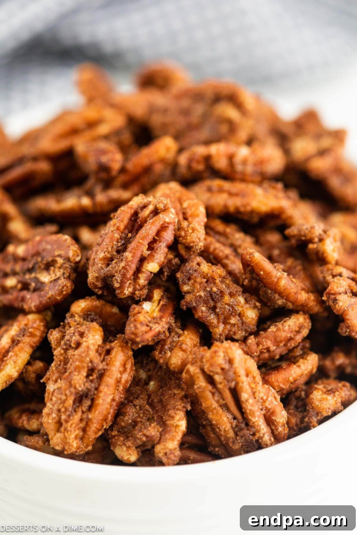 Irresistible Air Fryer Candied Pecans 10 Air fryer candied pecans in a bowl.
