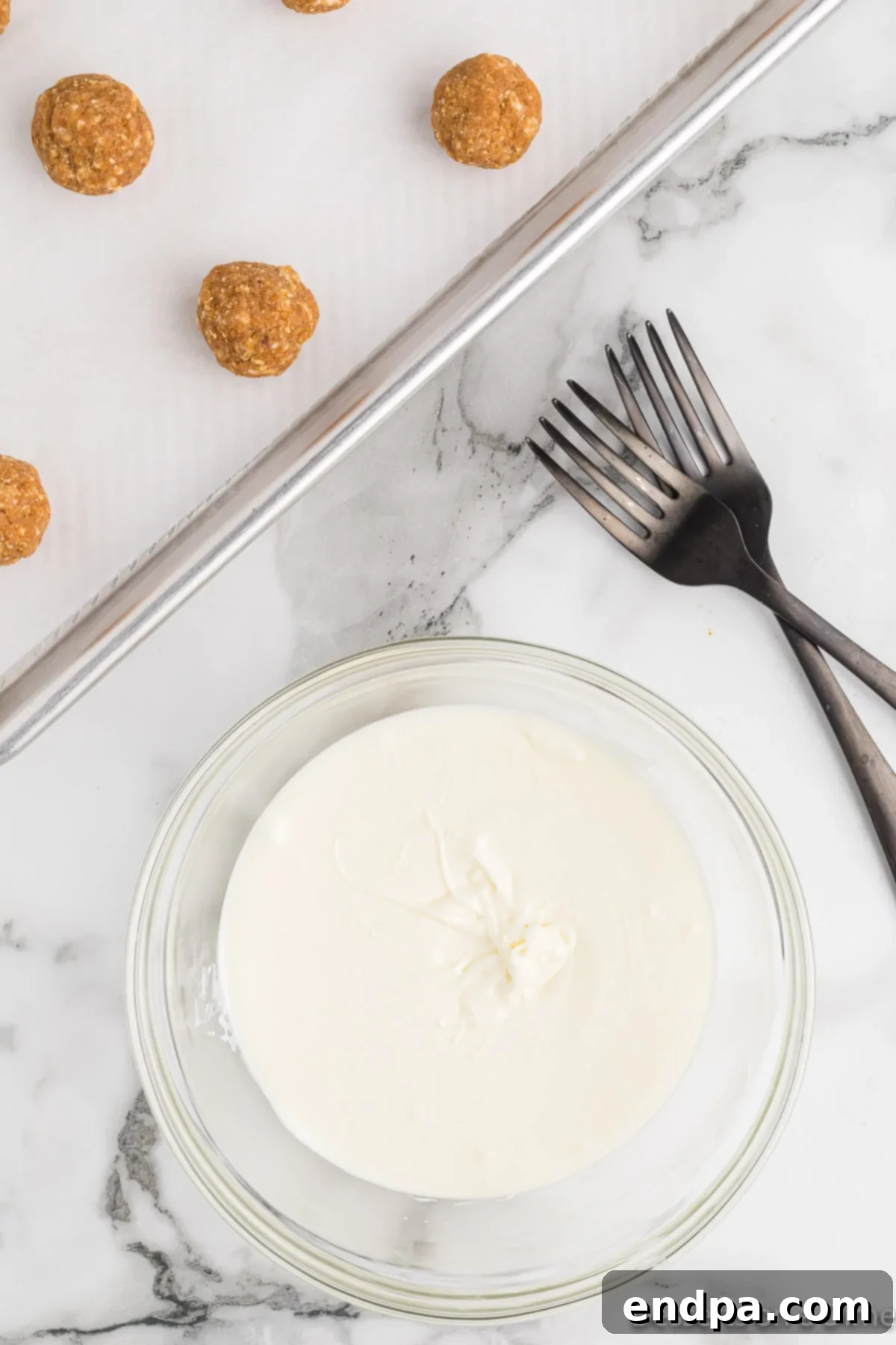 A bowl of fully melted white chocolate, ready for dipping.
