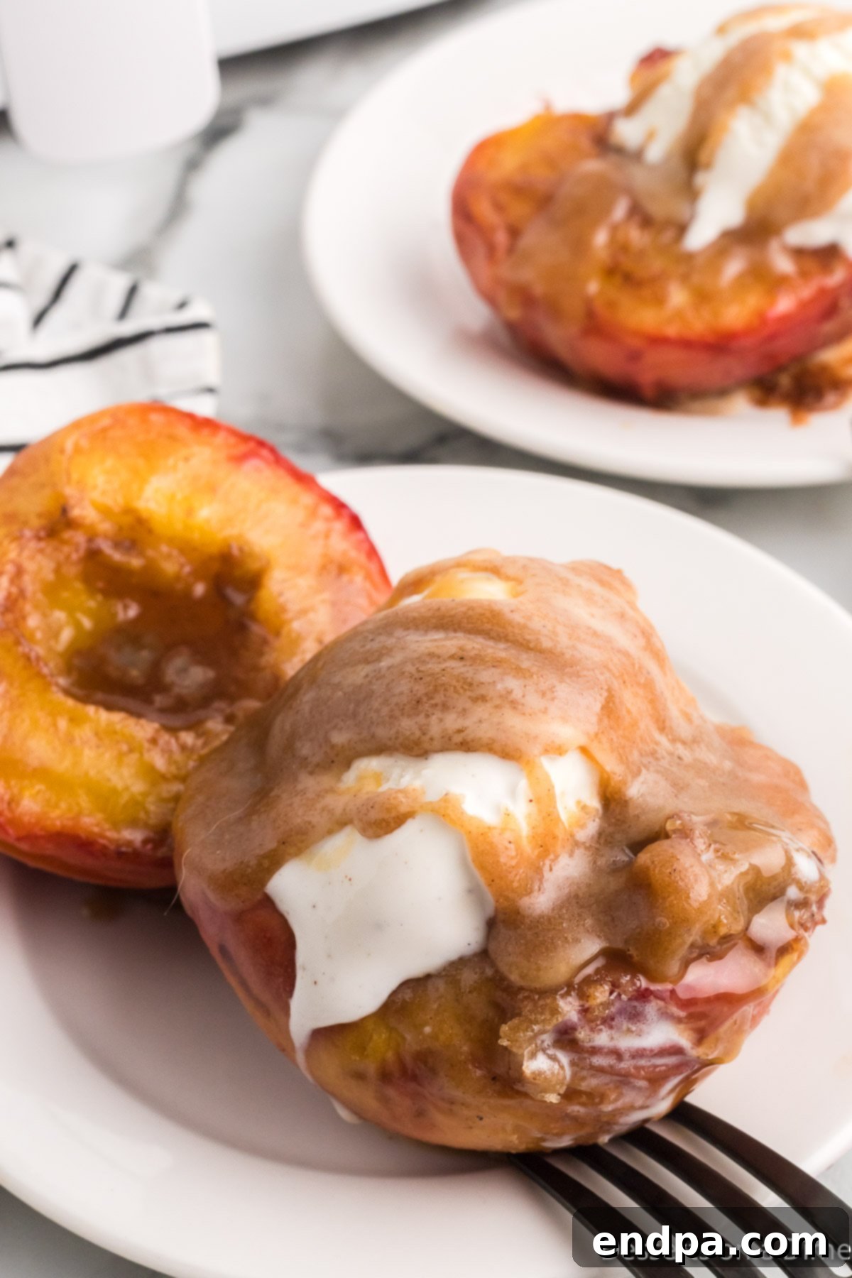 Golden Air Fryer Peaches 11 Peaches topped with ice cream.