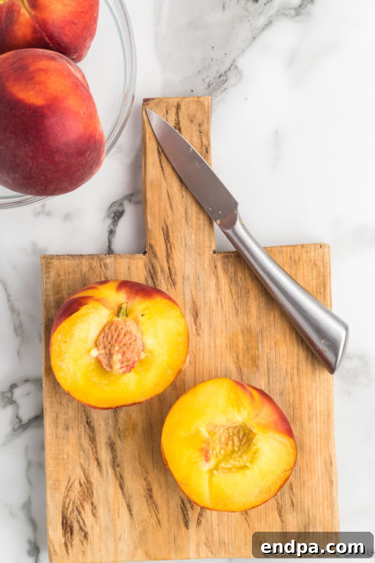Golden Air Fryer Peaches 5 Peaches cut in half.