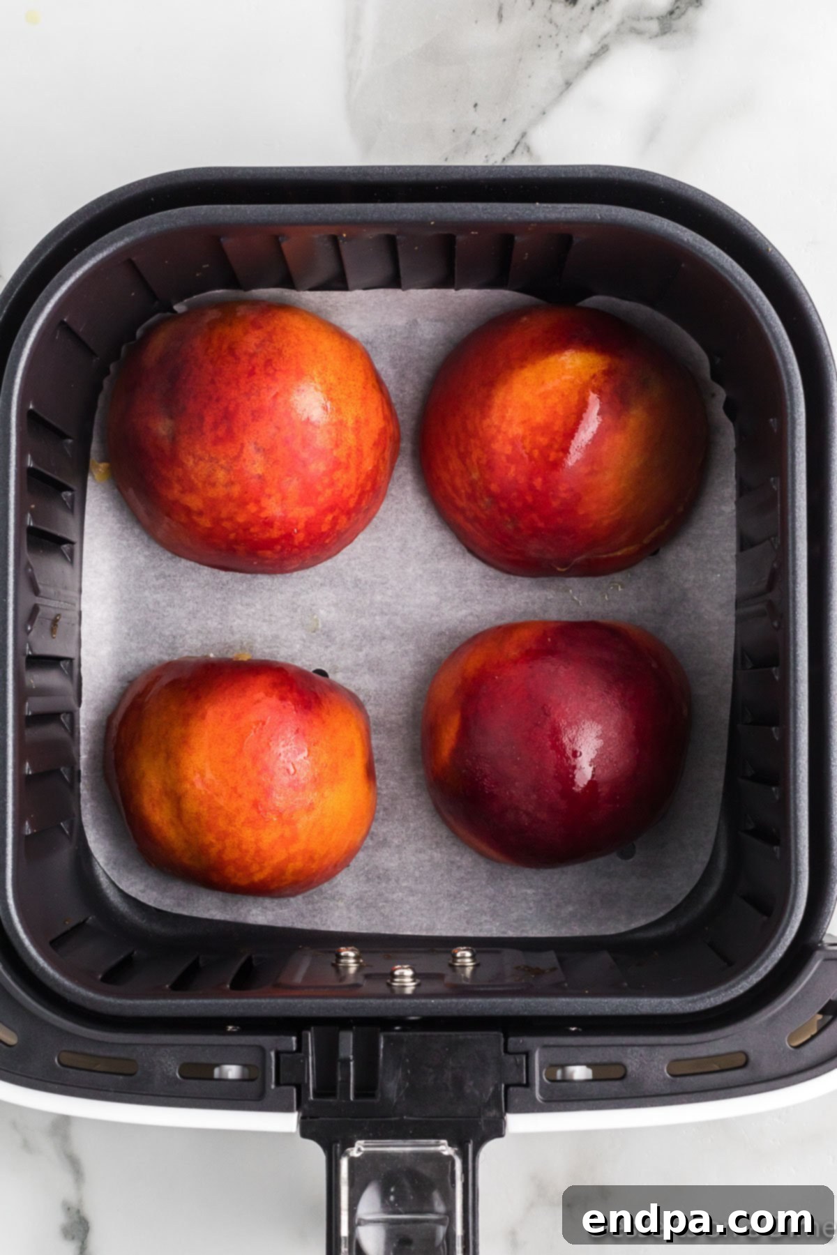 Golden Air Fryer Peaches 7 Peaches cut in half and placed in air fryer.