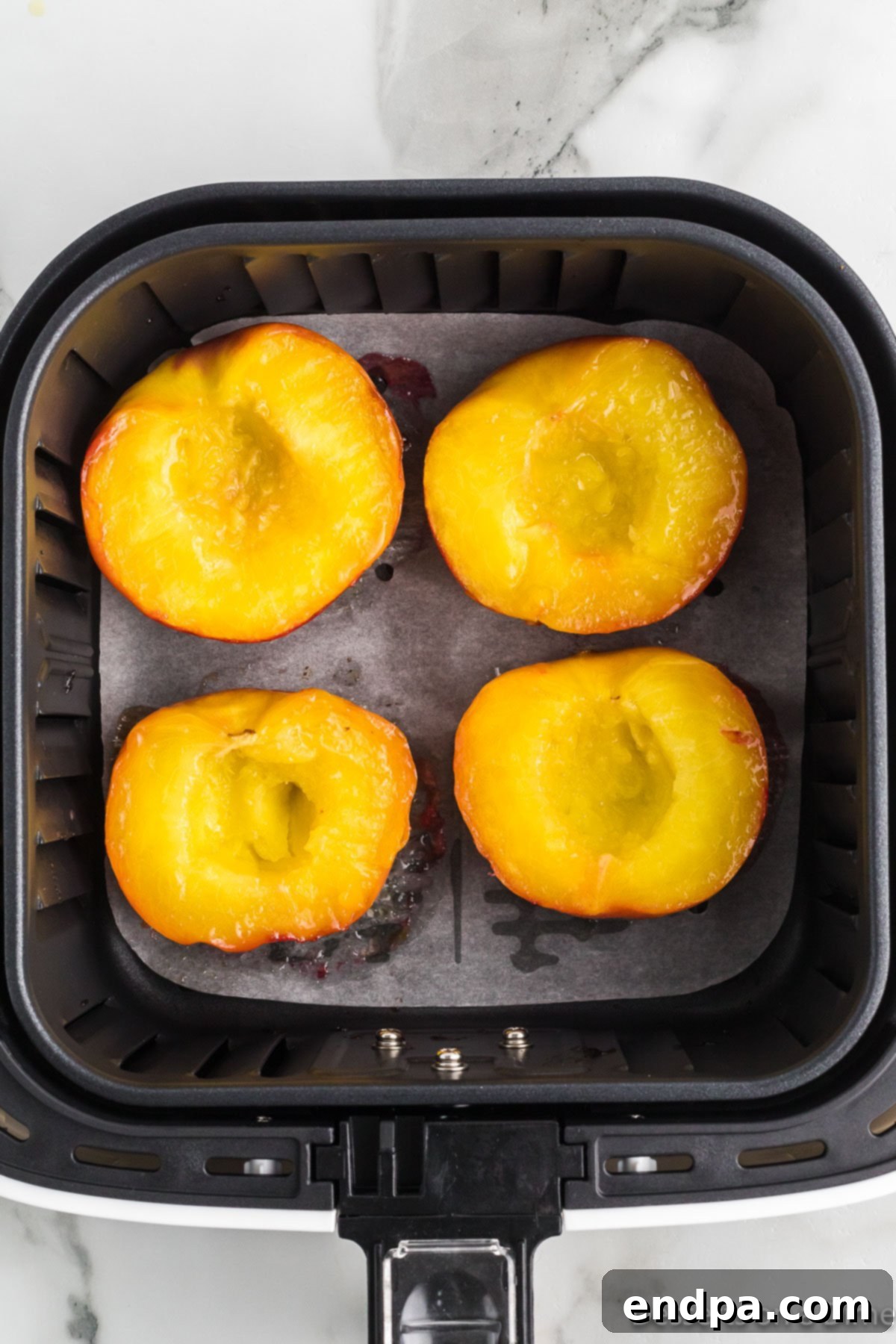 Golden Air Fryer Peaches 8 Peaches flipped over.