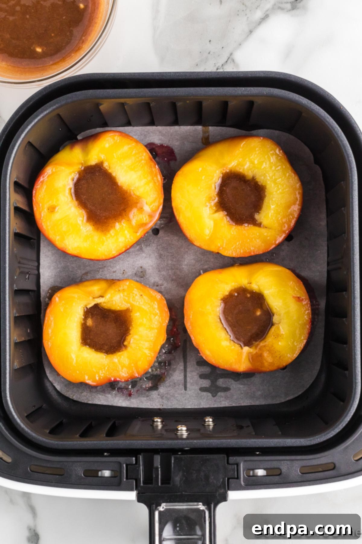 Golden Air Fryer Peaches 9 Peaches will butter mixture spread on each one.