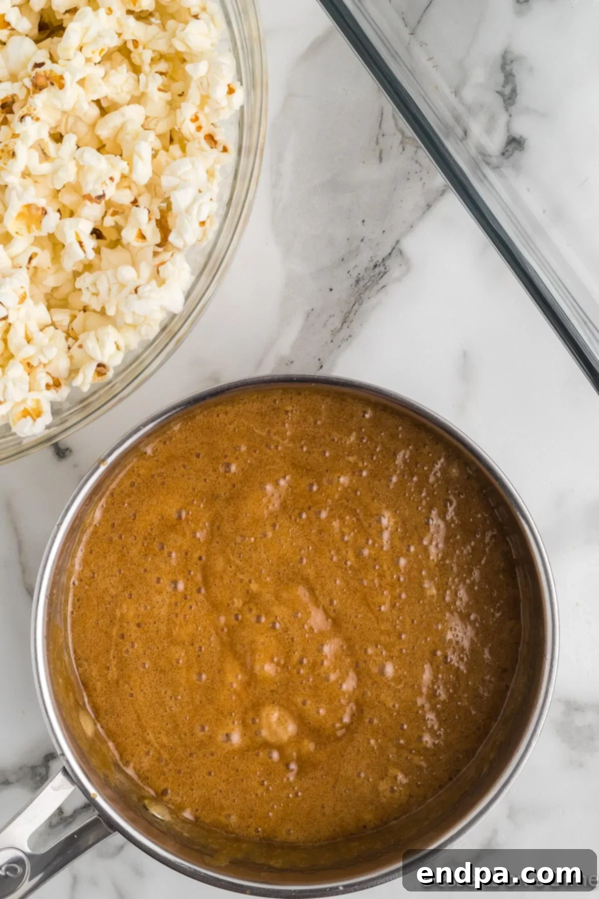 The boiling toffee mixture, a deep golden color, after baking soda and vanilla extract have been stirred in.