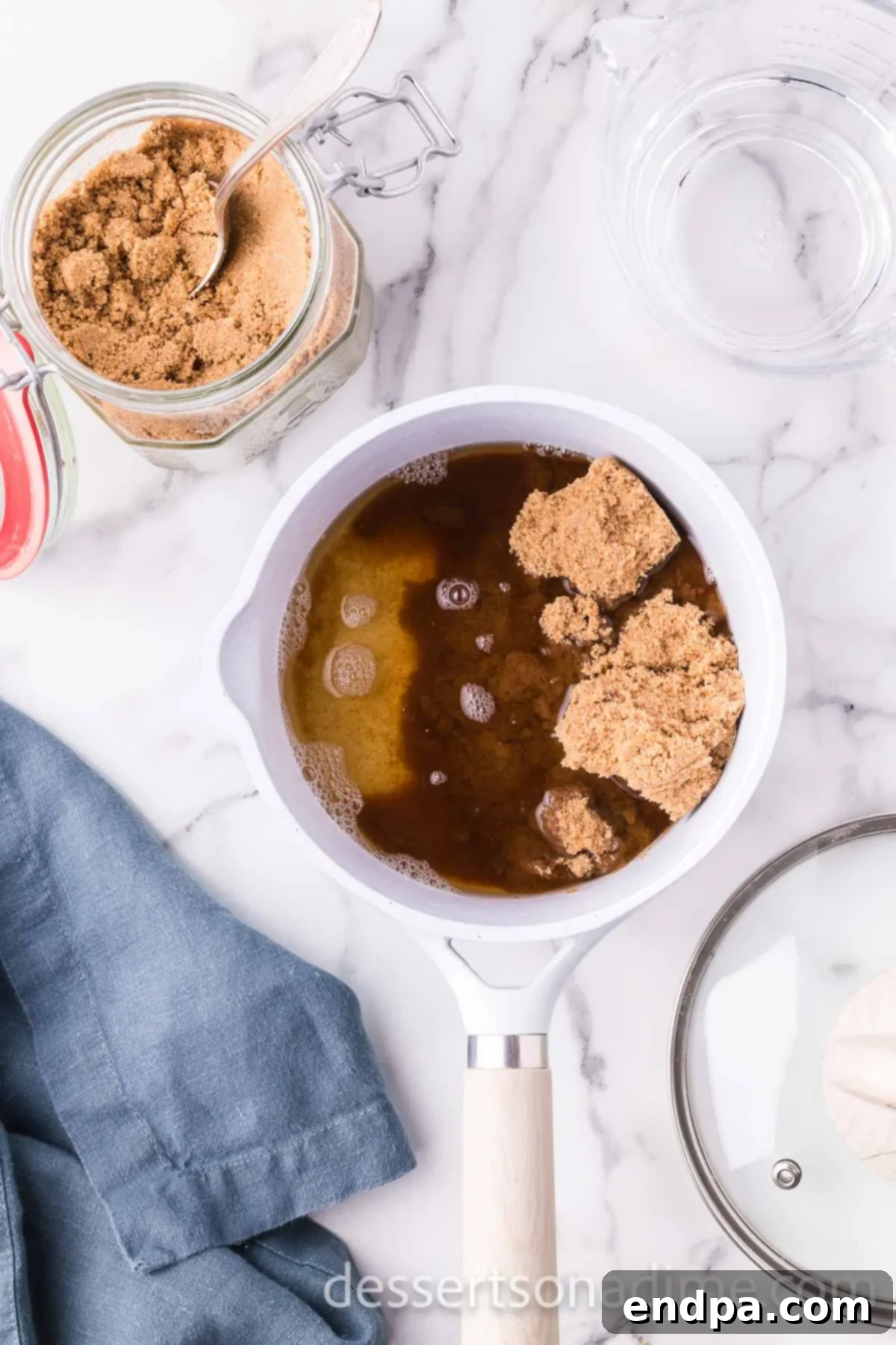Brown sugar and water expertly combined in a saucepan, ready for gentle heating.