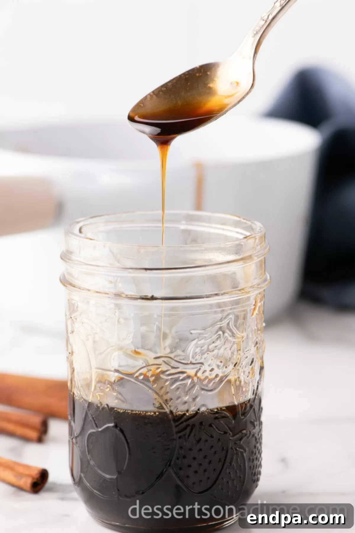 A sealed glass jar filled with fresh homemade brown sugar syrup, stored in the refrigerator for easy access.