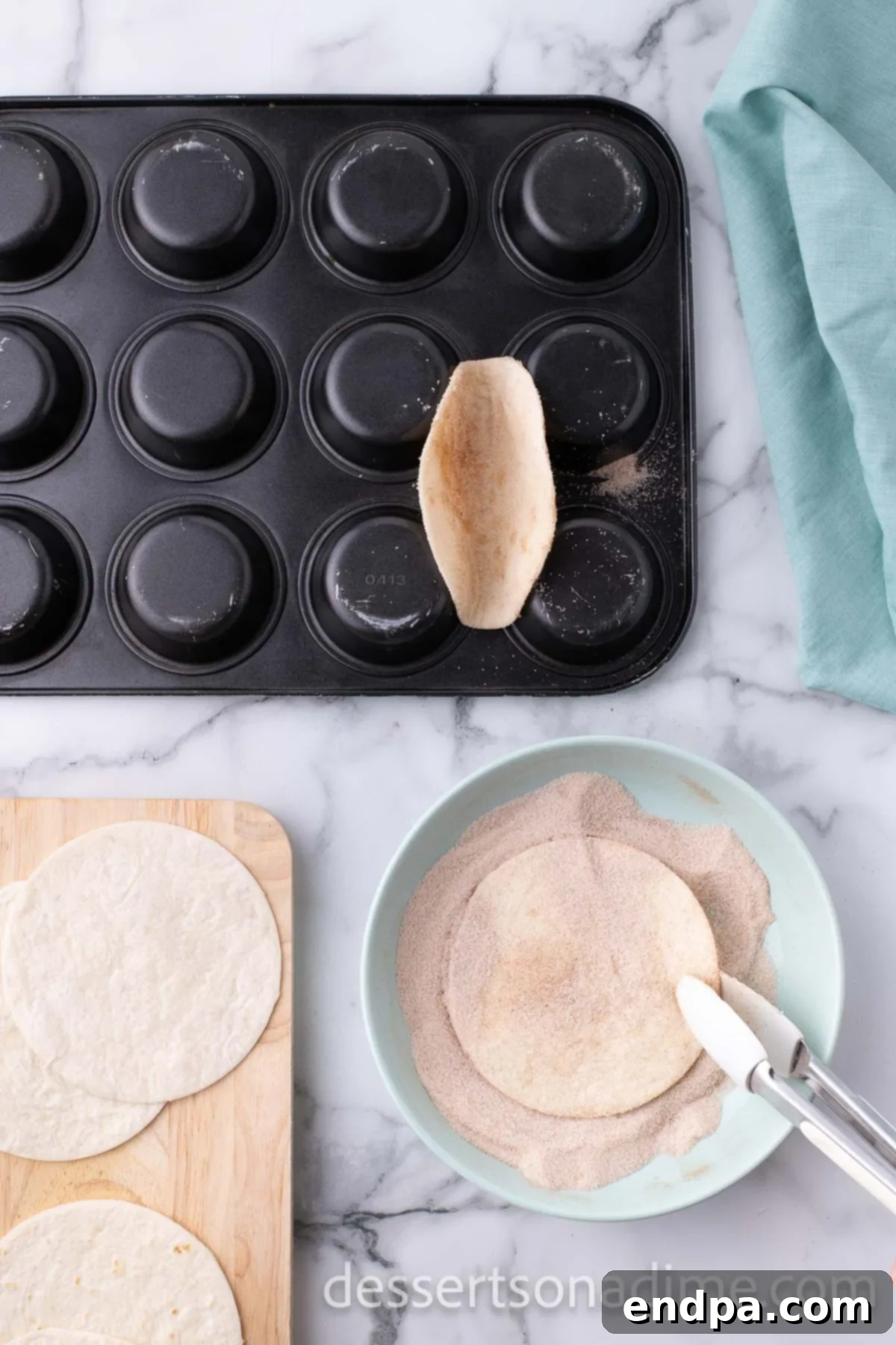 Upside down muffin pan with tortillas on top. 