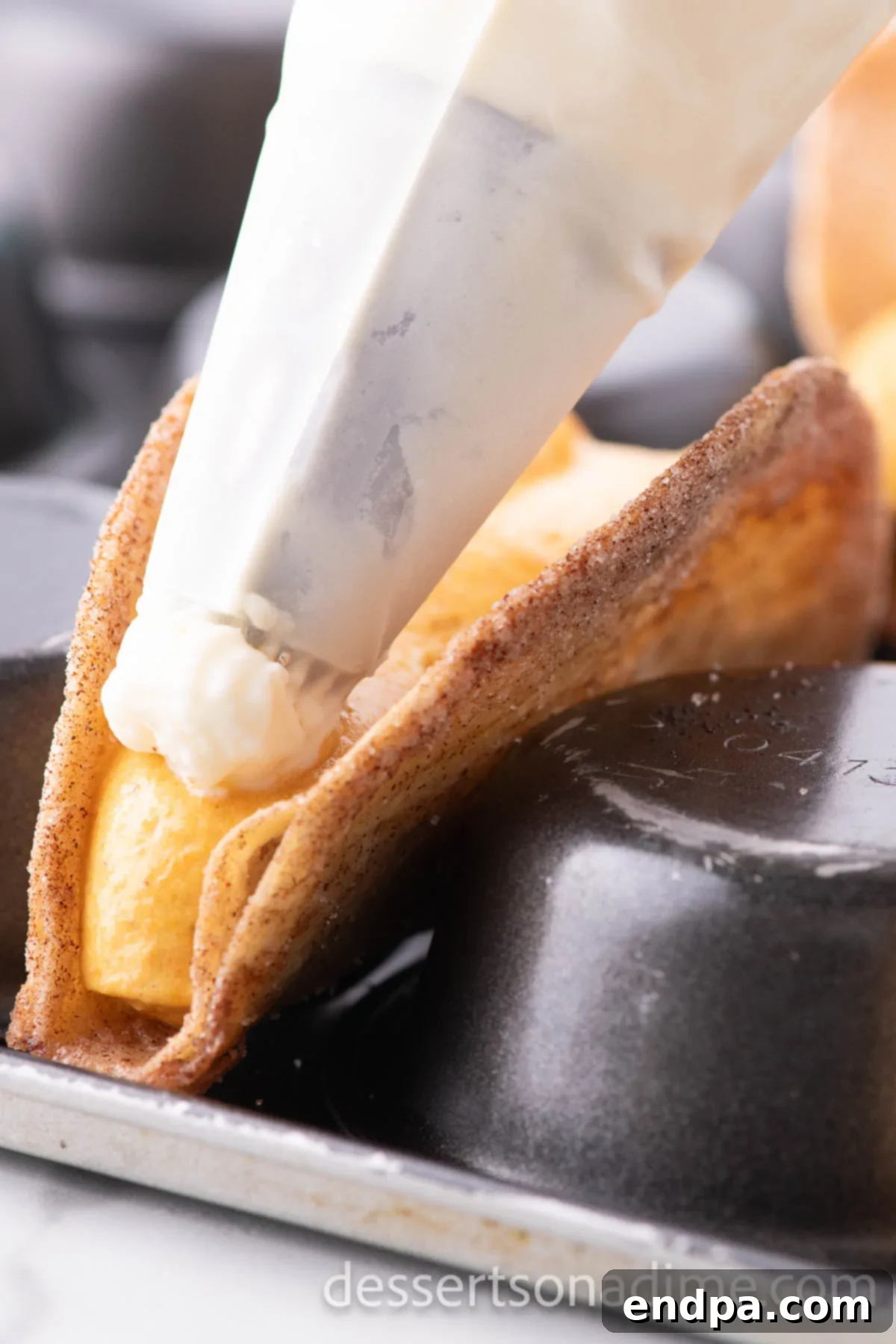 Pumpkin mixture and whipped topping piped on to tacos. 