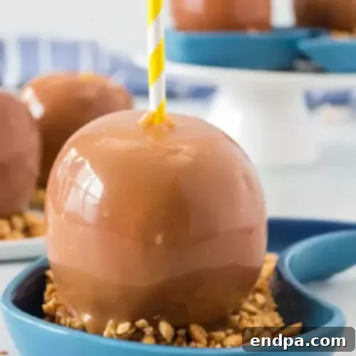 97 Effortless Autumn Delights 18 Homemade Caramel Apples on sticks, ready to be enjoyed.