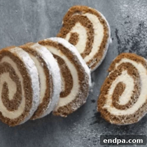 97 Effortless Autumn Delights 21 A beautifully sliced Pumpkin Cream Cheese Roll, showing the spiral layers.