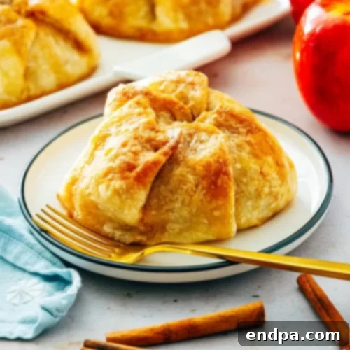 97 Effortless Autumn Delights 22 Warm Apple Dumplings in a bowl, drizzled with sauce.