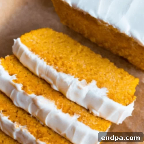 97 Effortless Autumn Delights 23 A loaf of Keto Pumpkin Bread, sliced, showing its moist texture.