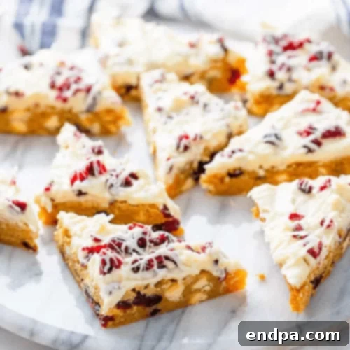 97 Effortless Autumn Delights 29 Cranberry Bliss Bars with white chocolate drizzle and cream cheese frosting.