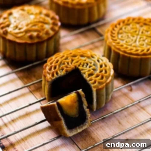 97 Effortless Autumn Delights 30 Traditional Mooncakes with intricate patterns on their golden crusts.