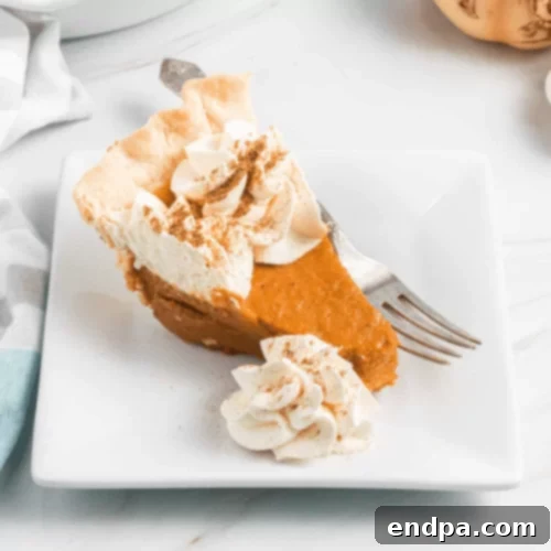 97 Effortless Autumn Delights 44 A light and fluffy Pumpkin Chiffon Pie with a dollop of whipped cream.