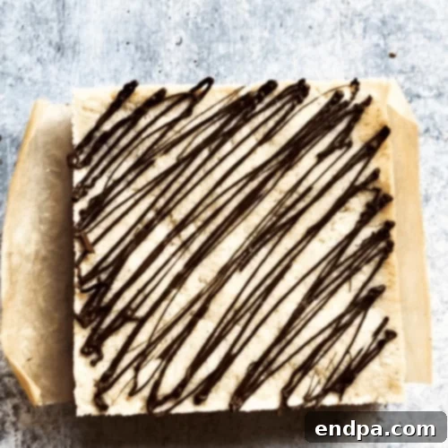 97 Effortless Autumn Delights 46 Coconut Burfi Brownie Bites, showing layers of brownie and coconut.