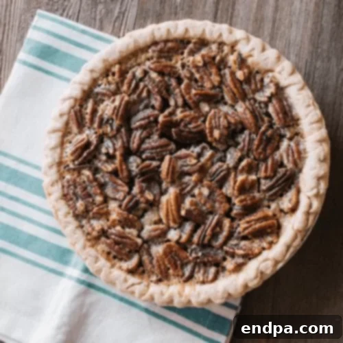 97 Effortless Autumn Delights 52 A slice of Pumpkin Pecan Pie, showing distinct layers of pumpkin and pecan filling.