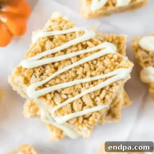 97 Effortless Autumn Delights 8 Pumpkin Rice Krispie Treats shaped like pumpkins, decorated with frosting.