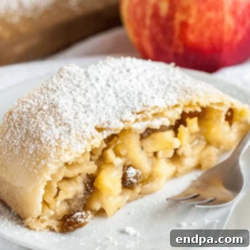 97 Effortless Autumn Delights 55 A golden-brown Apple Strudel, sliced to reveal the spiced apple filling.