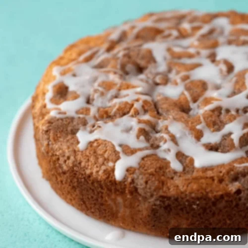 97 Effortless Autumn Delights 56 A slice of moist Cinnamon Apple Cake with streusel and a glaze.