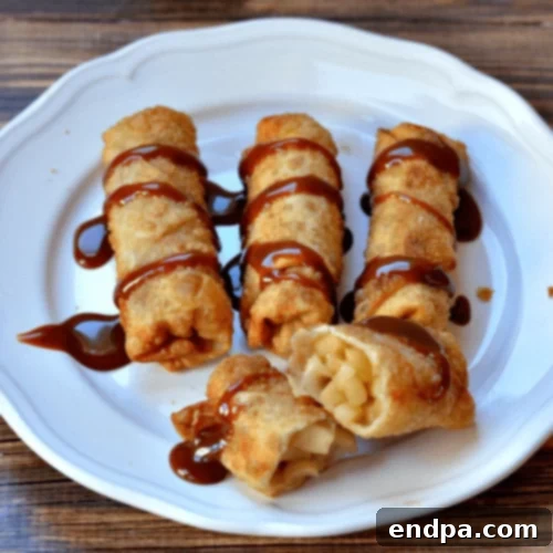 97 Effortless Autumn Delights 66 Crispy Caramel Apple Pie Egg Rolls, drizzled with caramel sauce.