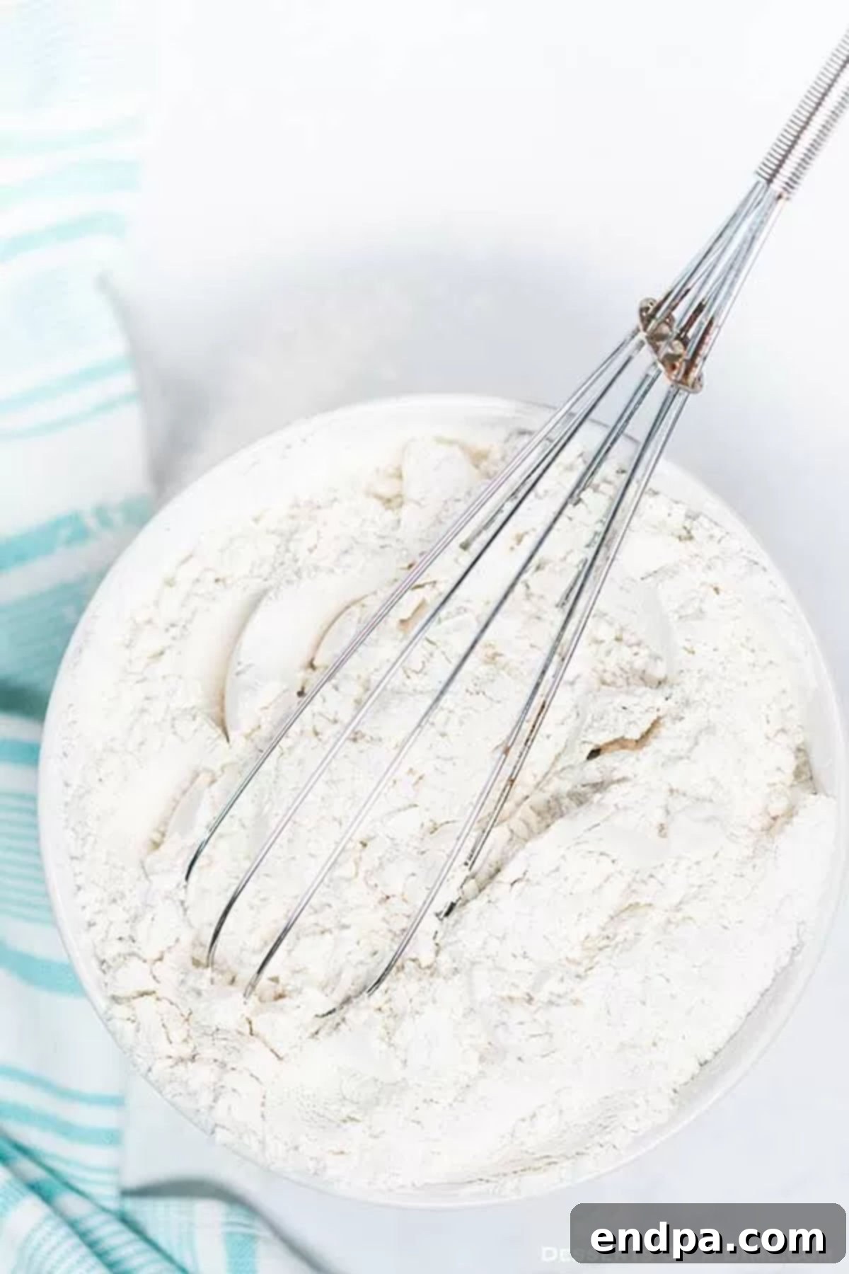 Bake Better with Homemade Cake Flour 3 Remaining flour and cornstarch being whisked together in a mixing bowl.