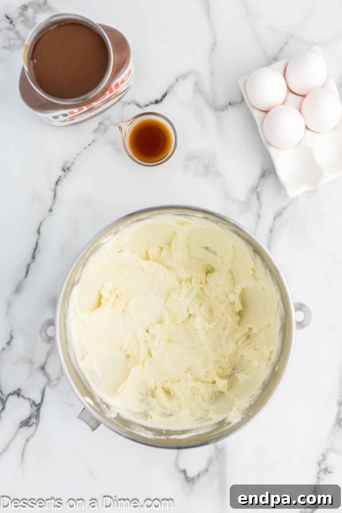 Beating softened cream cheese and granulated sugar together in a large mixing bowl