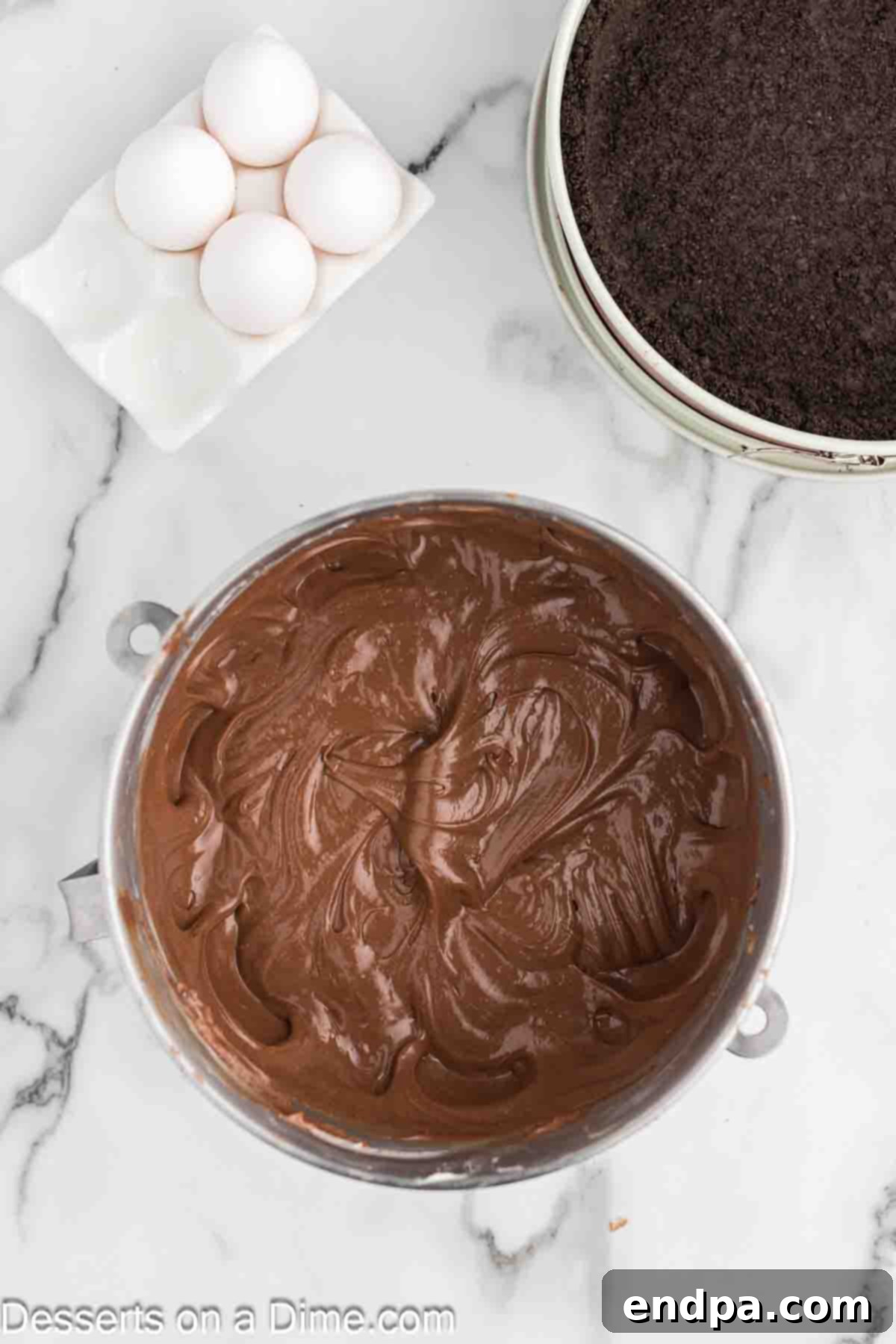 Gently mixing eggs into the Nutella cream cheese mixture, one at a time