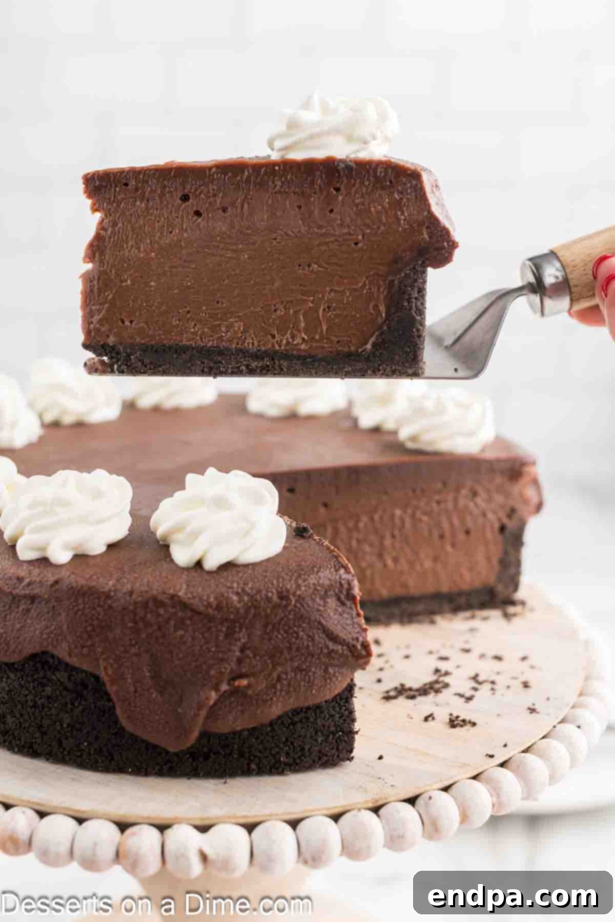 A perfect slice of Nutella Cheesecake resting on a spatula