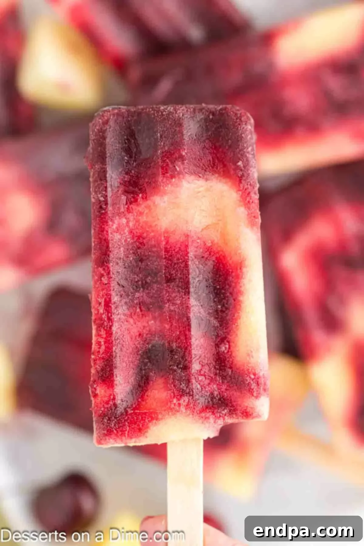 Close up image of cherry pineapple popsicle