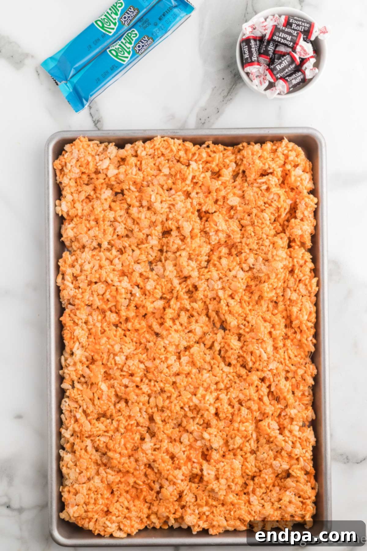 Pumpkin Patch Krispie Treats 11 The Rice Krispies and marshmallow mixture spread evenly into a large baking dish to cool.