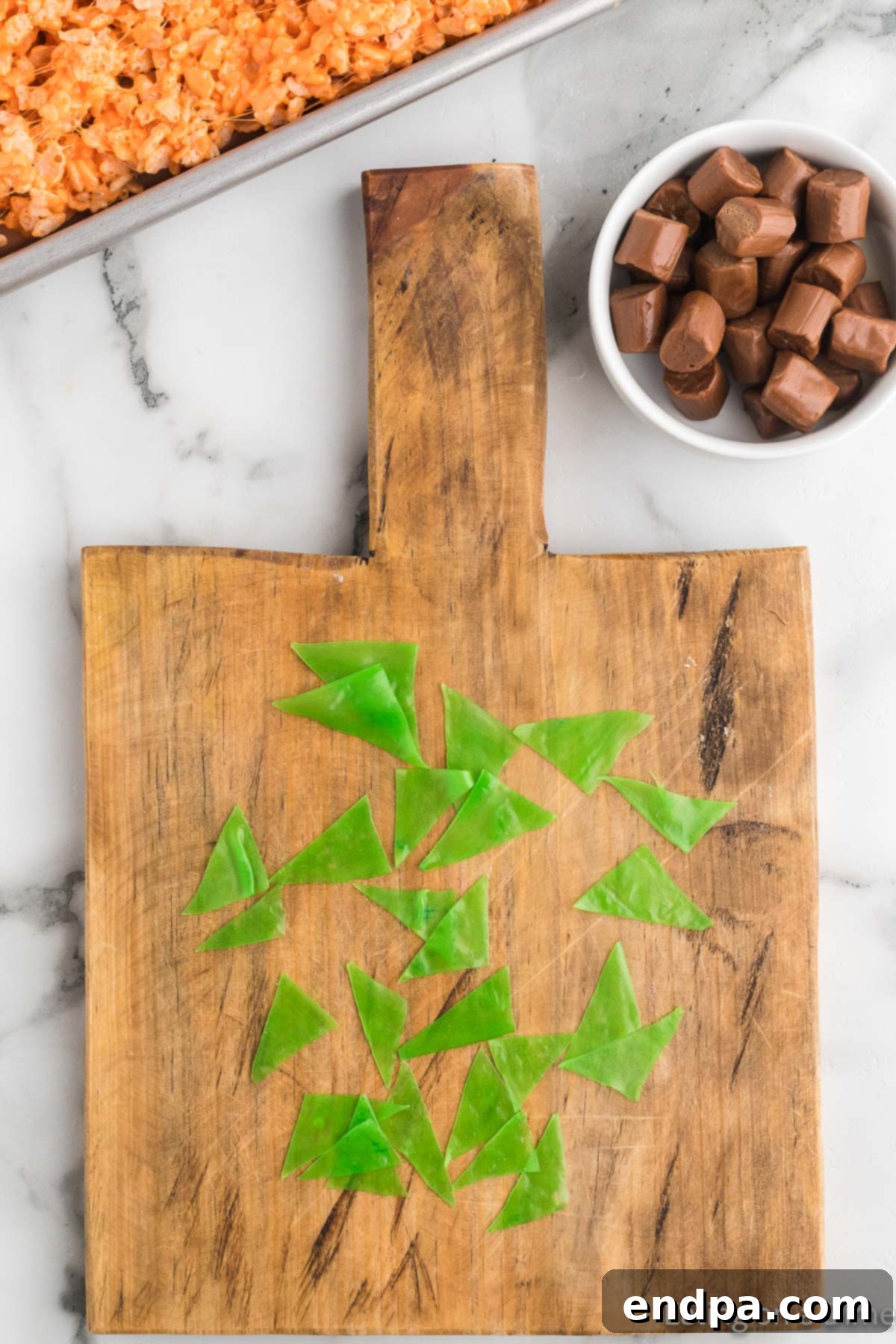 Pumpkin Patch Krispie Treats 13 Green fruit roll-ups cut into small triangles, ready to be used as pumpkin leaves.