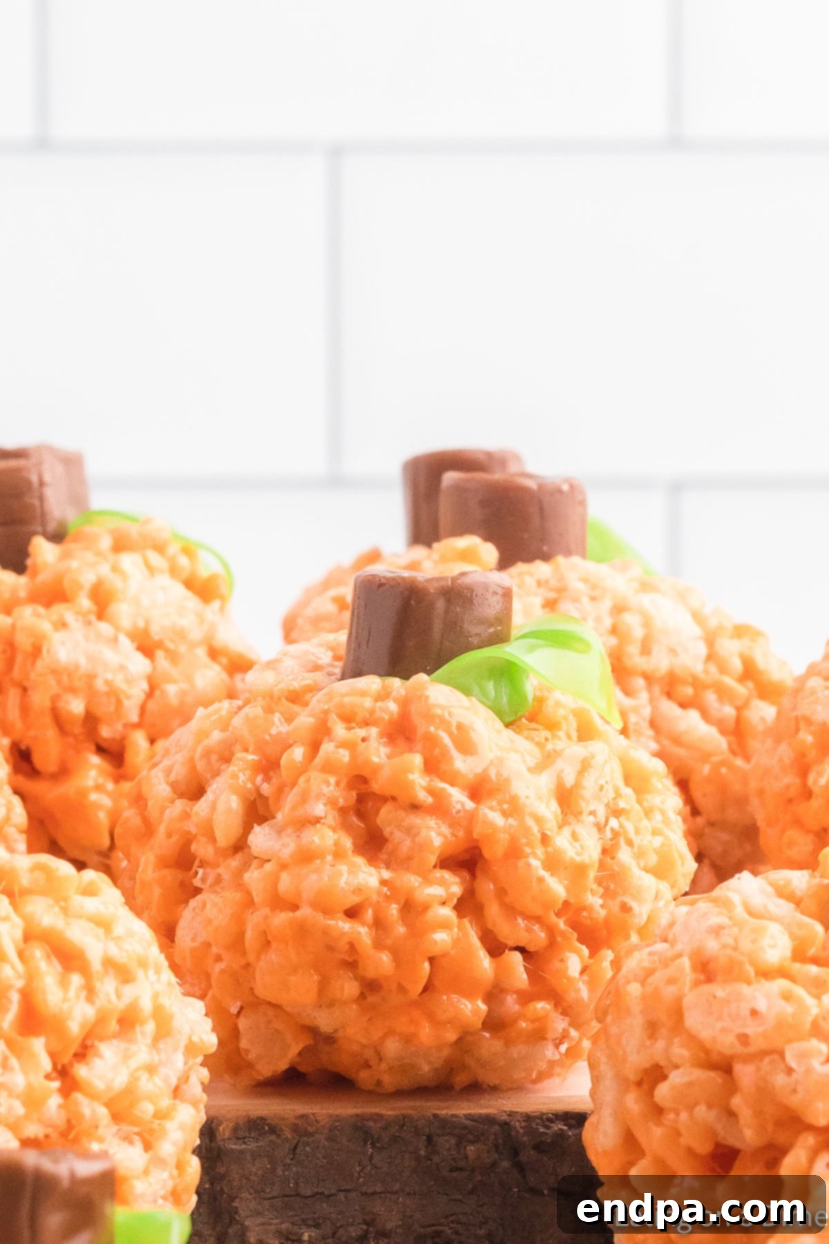 Pumpkin Patch Krispie Treats 15 A tray filled with beautifully decorated Rice Krispie Treat Pumpkins, ready to be served at a fall or Halloween event.