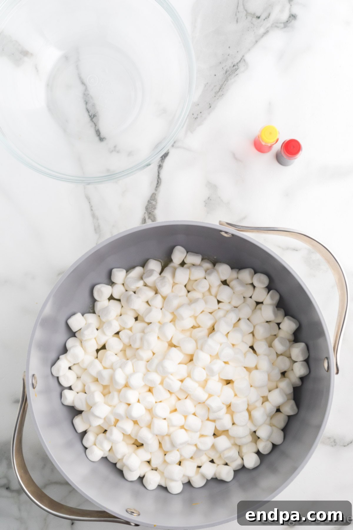 Pumpkin Patch Krispie Treats 6 Mini marshmallows added to the melted butter in the saucepan.