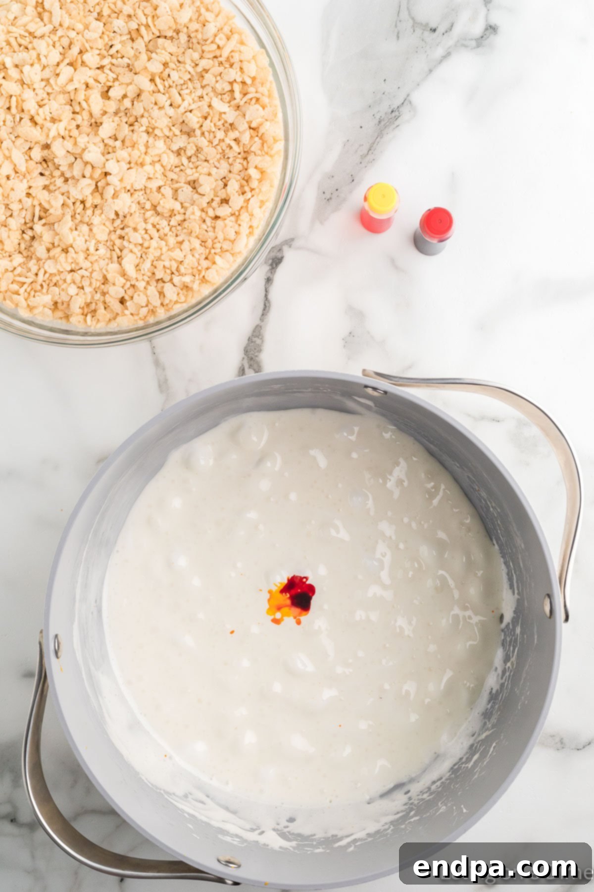 Pumpkin Patch Krispie Treats 8 Drops of yellow and red food coloring being added to the melted marshmallow and butter mixture.