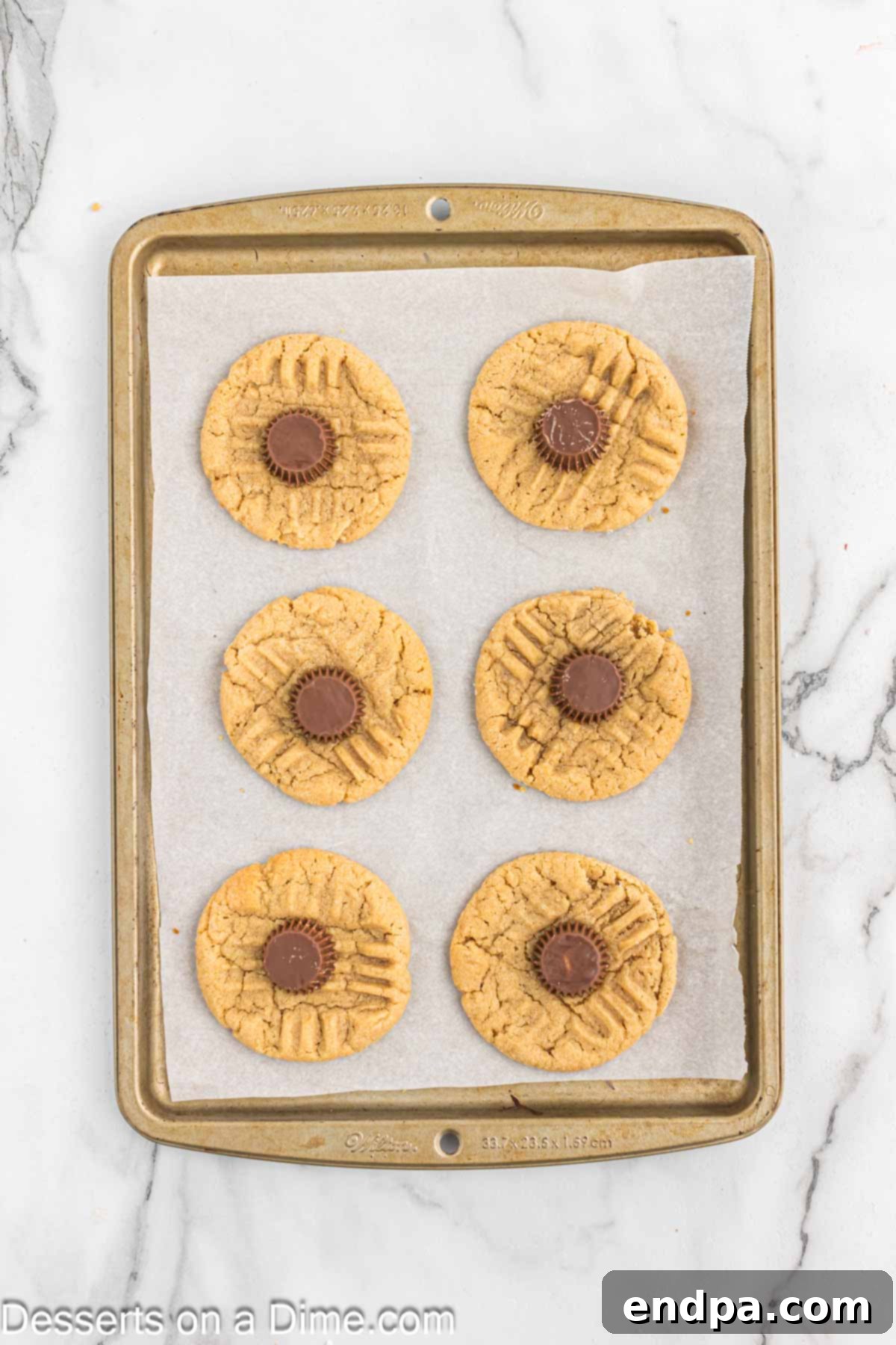 Reese's Peanut Butter Cups added upside down to the center of each baked cookie.