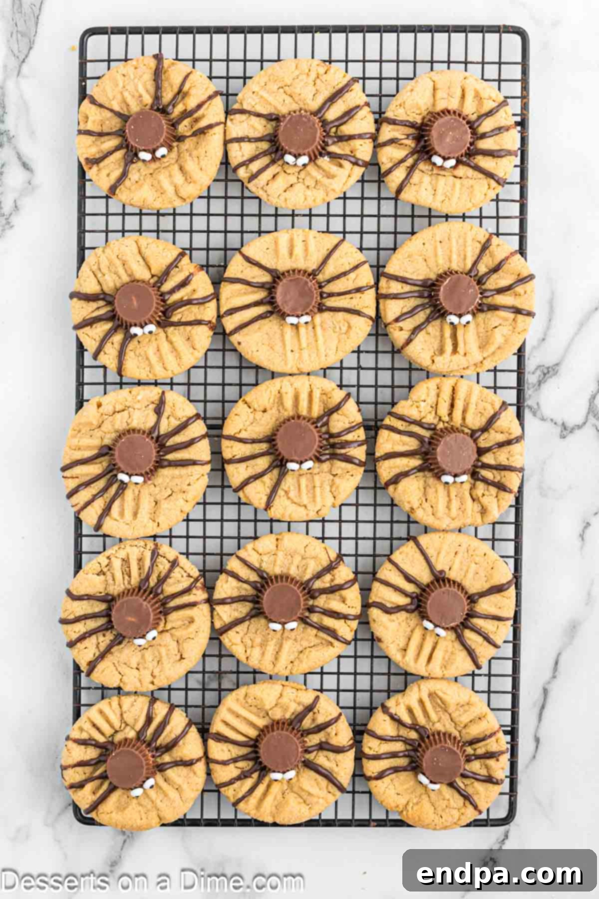 Melted chocolate piped onto each cookie to create spider legs around the peanut butter cup body.