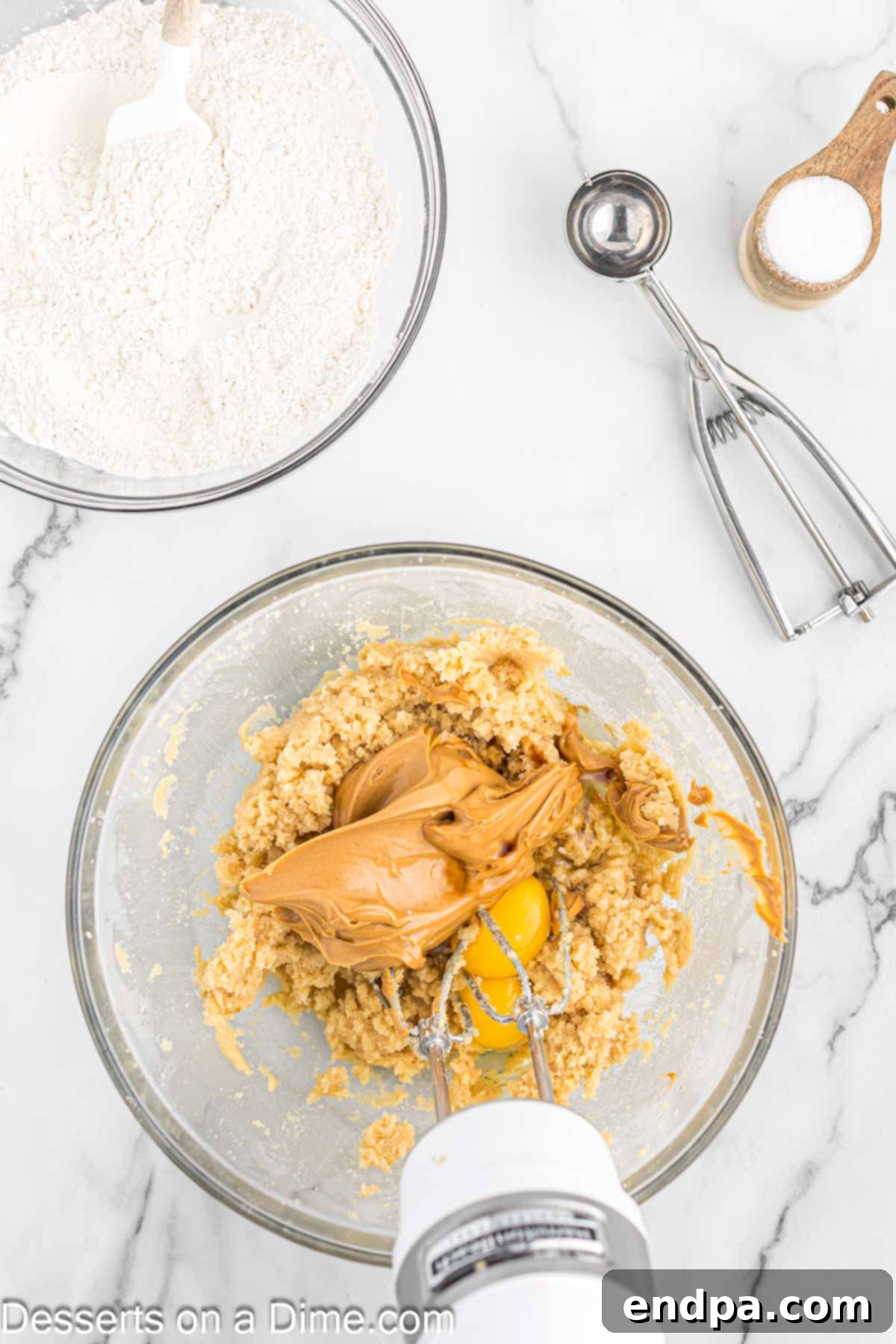 Peanut butter, eggs, and vanilla extract mixed into the butter and sugar mixture.