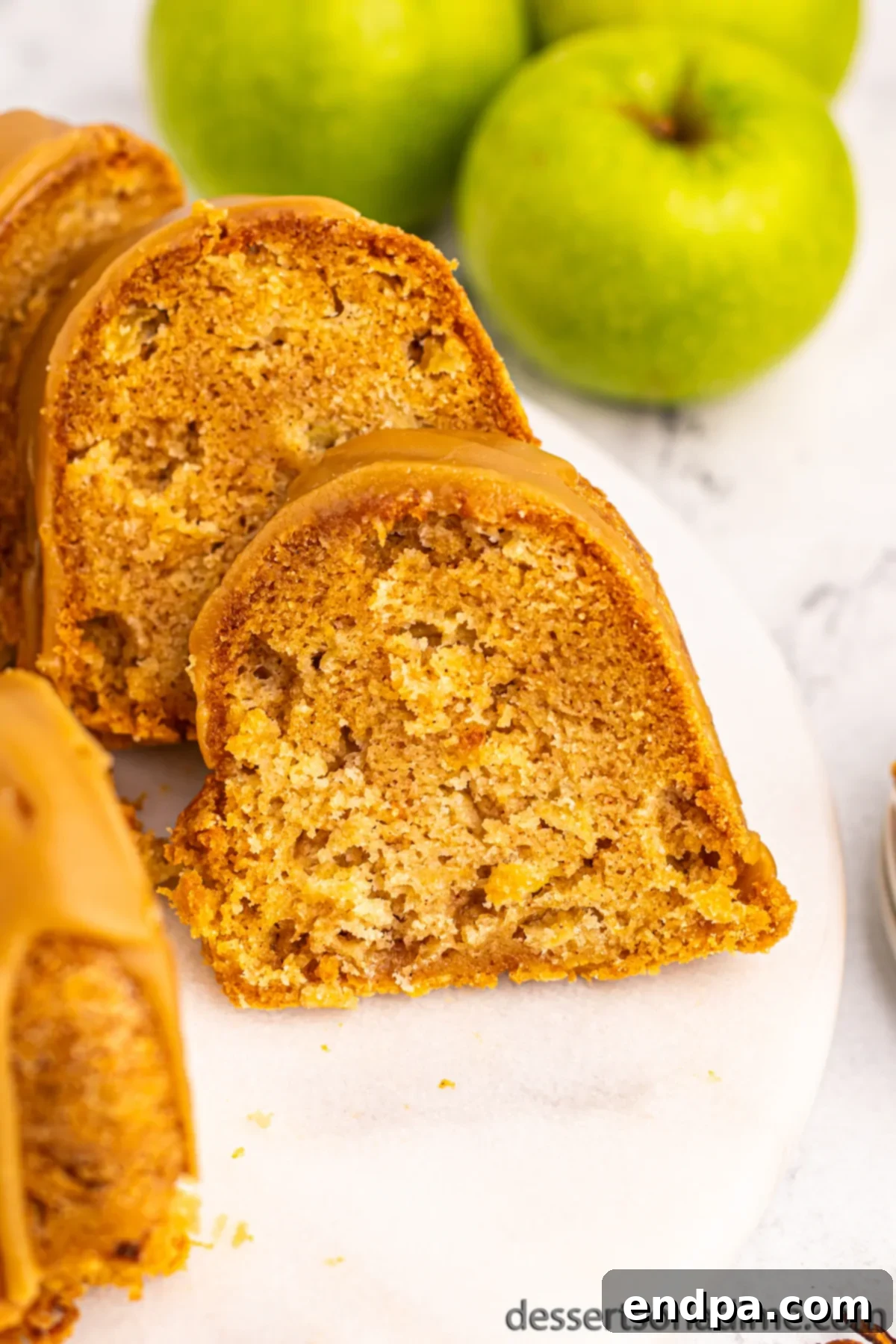Apple bundt cake slices arranged on a platter, ready to be served to guests.