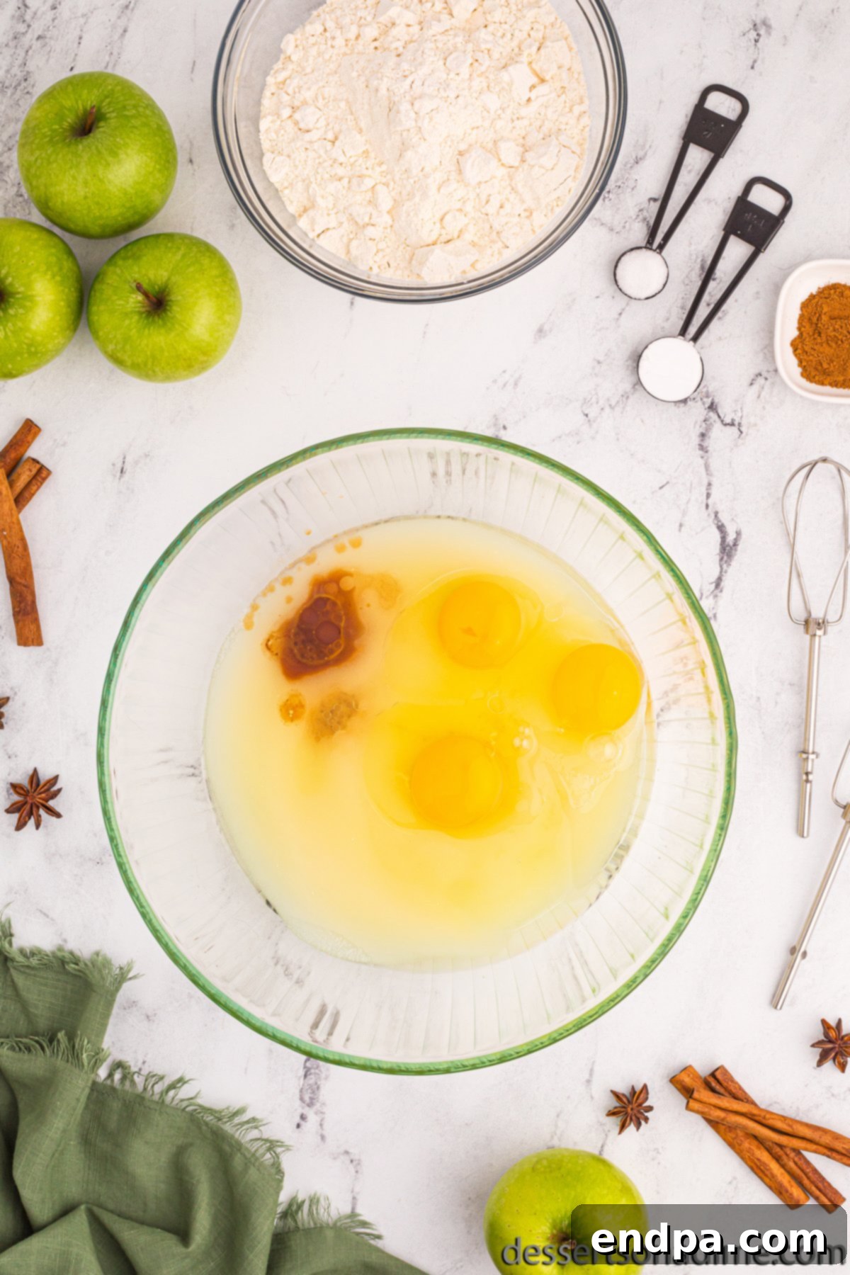 Bowl with sugar, oil, eggs and vanilla, wet ingredients ready to be mixed.