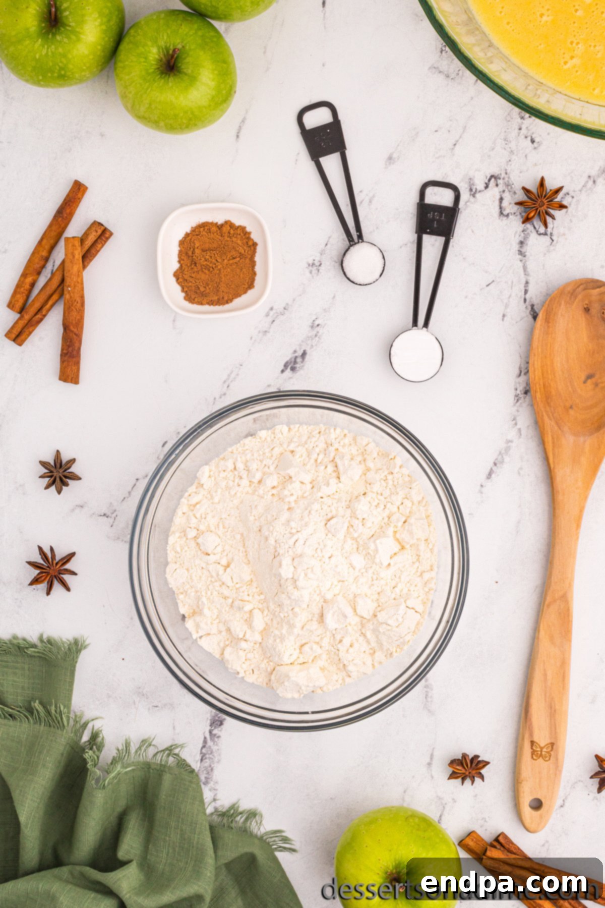Separate bowl with dry ingredients, flour, baking soda, ground cinnamon, and salt.