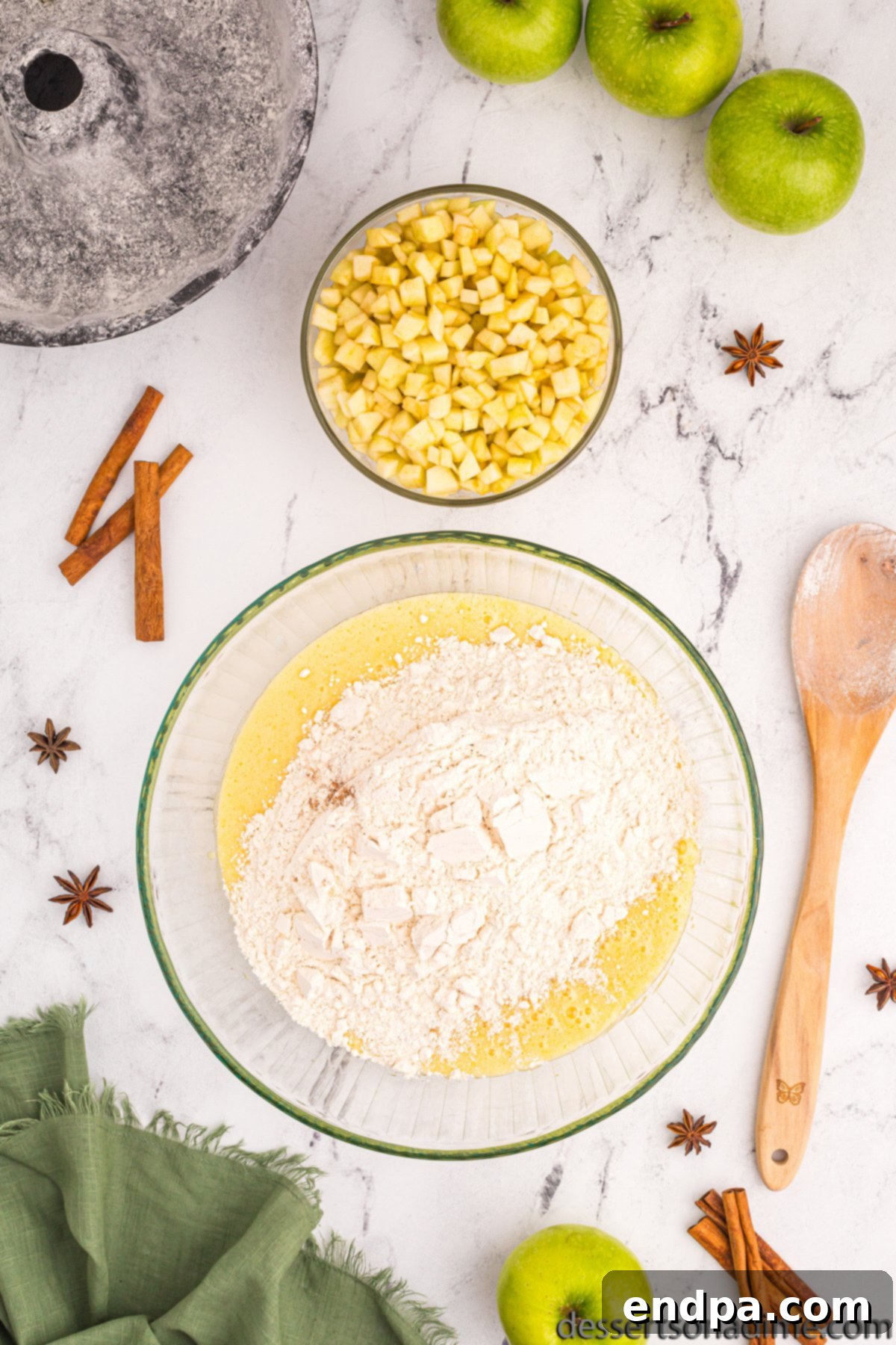 Mixing bowl with wet and dry ingredients combined to form the cake batter.
