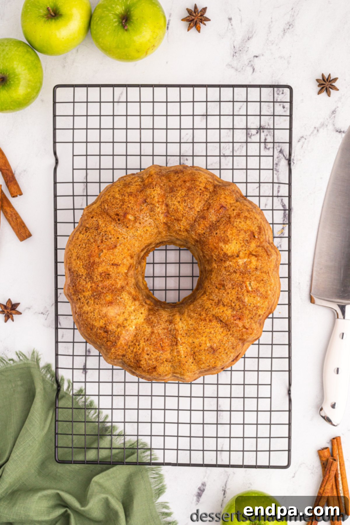 Baked bundt cake cooling on a wire rack after being removed from the pan.