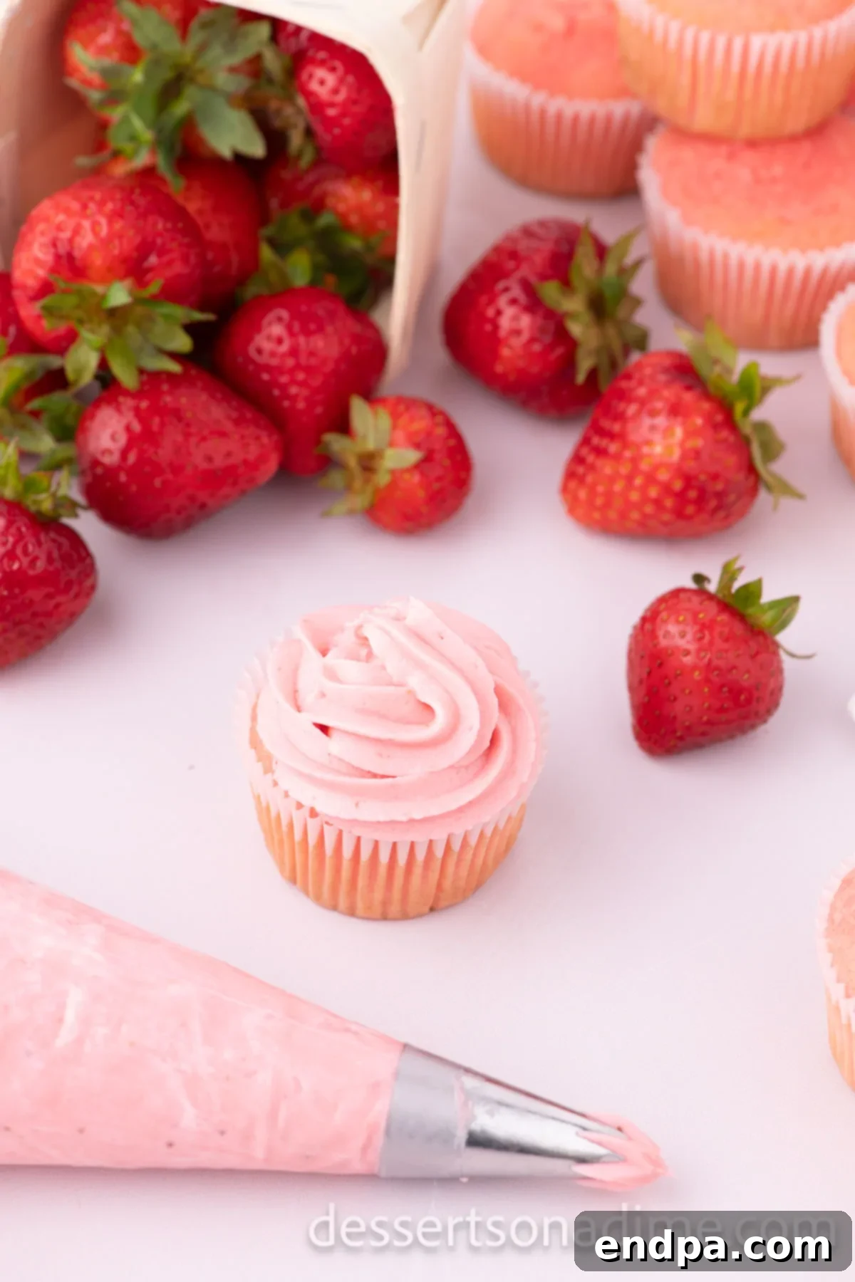 Velvety Strawberry Cream Cheese Frosting 9 Finished Strawberry Cream Cheese Frosting elegantly piped onto a delicious cupcake, ready to be enjoyed.