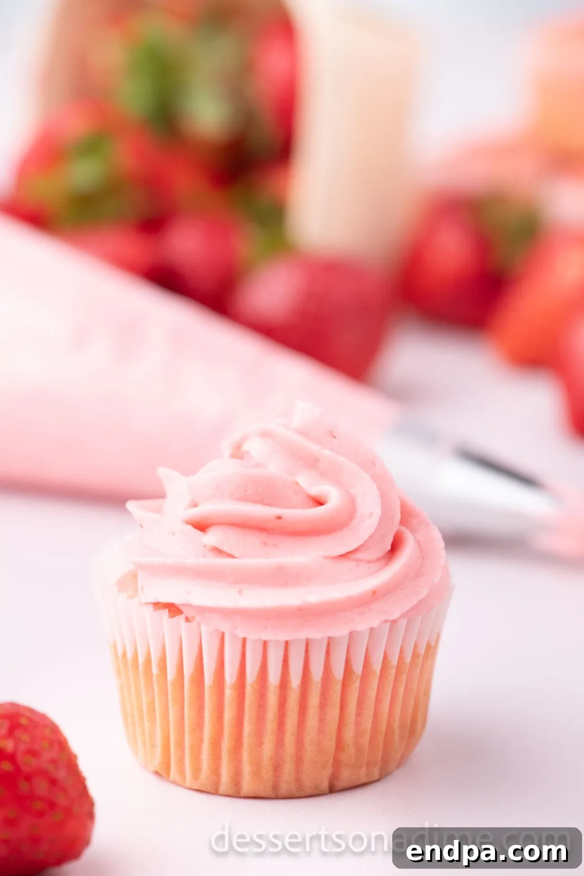 Velvety Strawberry Cream Cheese Frosting 10 A perfectly frosted cupcake with Strawberry Cream Cheese Frosting, ready for a party or sweet indulgence.