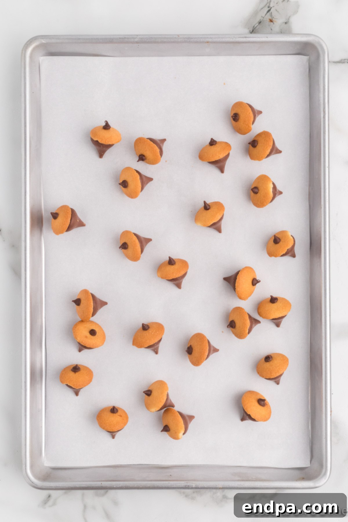 Acorn Chocolate Treasures 9 Acorns on parchment paper lined baking sheet.