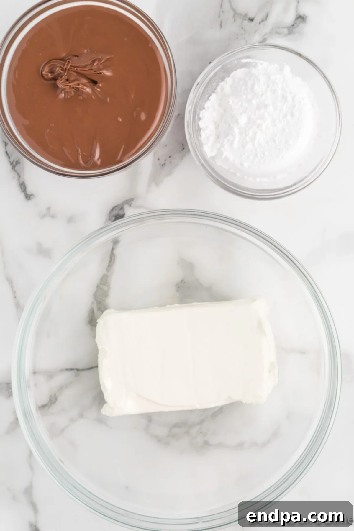 Softened cream cheese in a mixing bowl, ready to be beaten