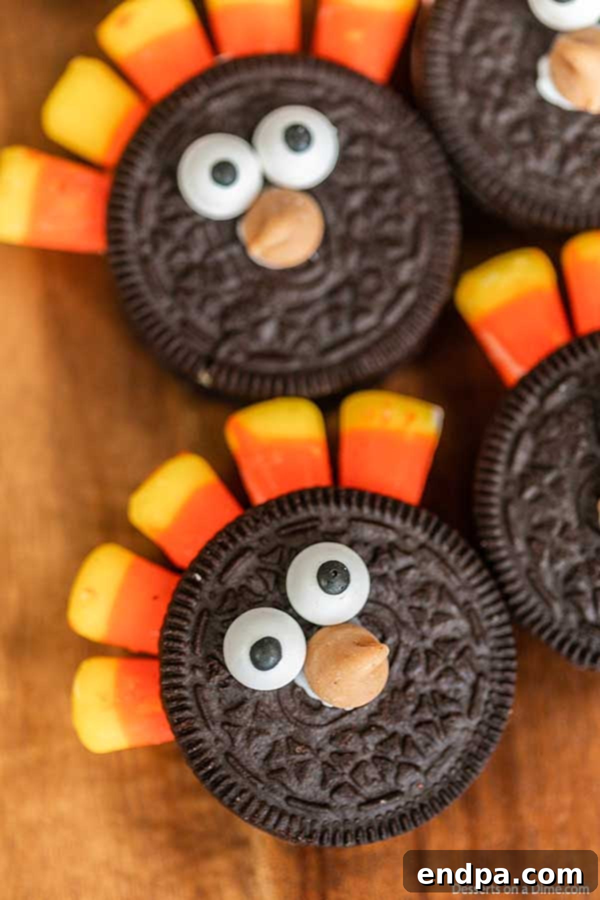 Oreo Turkey Cookies: Easy, Festive No-Bake Thanksgiving Treats for Kids Multiple adorable Oreo Turkey Cookies with candy corn feathers and candy eyes, arranged neatly on a rustic wooden board, ready for Thanksgiving festivities.