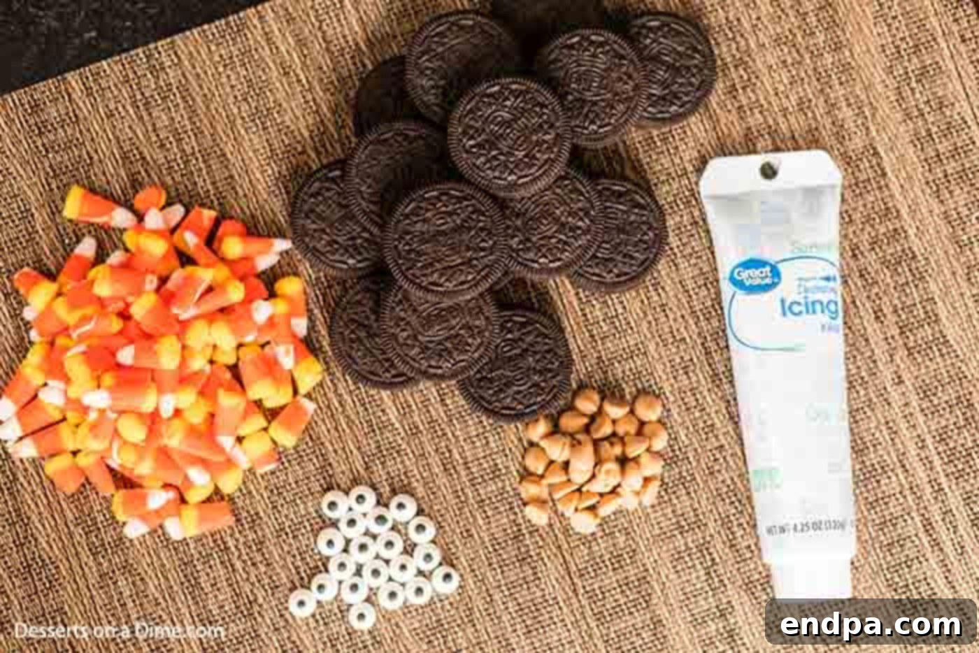 Ingredients for Oreo Turkey Cookies: Candy Corn, Oreos, Candy Eyes, Peanut Butter Chips Collection of ingredients required to make Oreo Turkey Cookies: a stack of Oreo cookies, a pile of colorful candy corn, a small bowl of candy eyes, and a handful of peanut butter chips, all laid out on a wooden surface.
