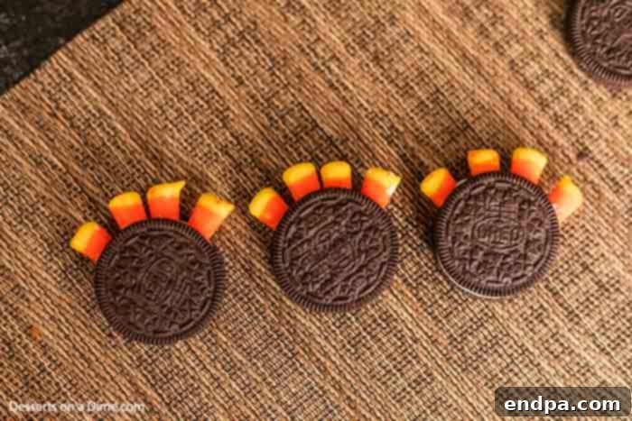 Gobble Gobble Oreo Delights 4 The two halves of the Oreo cookie are now reassembled, sandwiching the candy corn feathers securely in the cream filling, forming the body of the turkey.